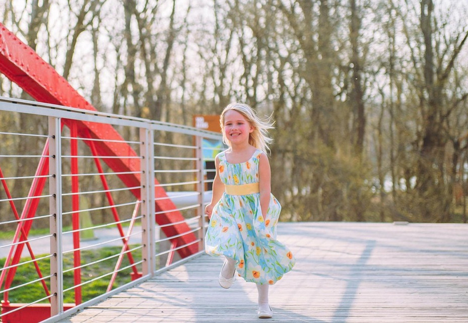 children running outside in a sunny field